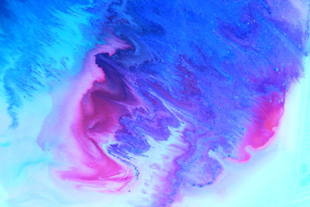 Abstract background of acrylic paint in blue, pink and purple tones.