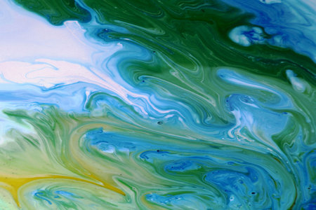 abstract background of blue and green paint mixing in a mixing bowlの写真素材