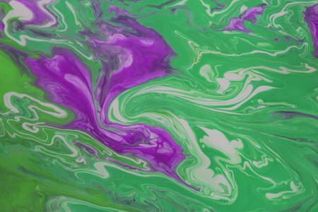 Abstract background of acrylic paint in green and purple tones. Liquid marble pattern.
