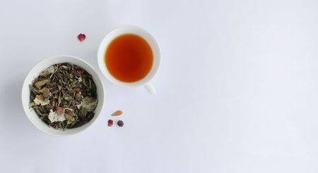 Loose green tea and tea in a cup on a white background. View from above.の写真素材