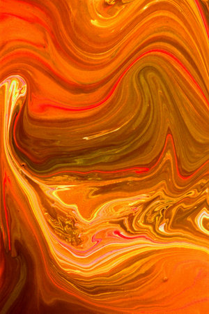Abstract background of acrylic paint in orange and yellow tones. Liquid marble texture