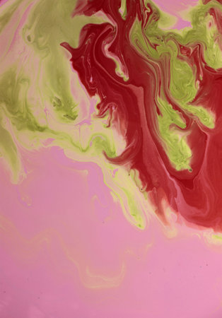 Abstract background of acrylic paint in red, green and yellow tones.