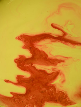 abstract background of yellow and red ink in water, closeup of photoの写真素材
