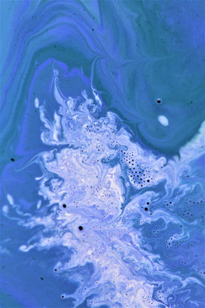 Abstract background of acrylic paint in blue tones. Liquid marble texture.