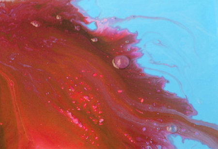 abstract background of red and blue oil paint on a water surfaceの写真素材