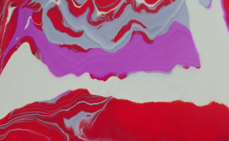 Abstract background of acrylic paint in red, white and blue tones.