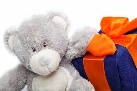 Gift pack and teddy bear on a white background の写真素材