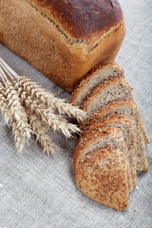 Fresh bread with ears of wheat on the canvas.の写真素材