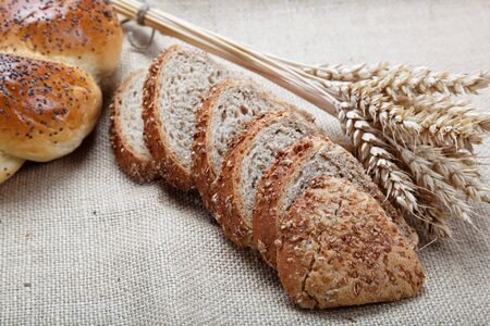 Fresh bread with ears of wheat on the canvas.の写真素材