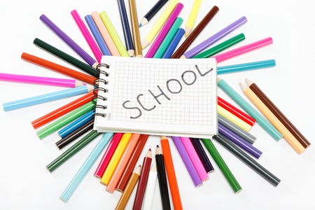 Notepad on a background of colored pencils.の写真素材