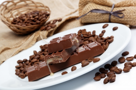 Chocolate and coffee beans on sacking.の写真素材