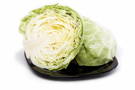 Fresh cabbage on a plate, isolated on white.の写真素材