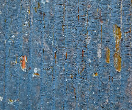 Cracked paint on a wooden surface. Grunge style background.