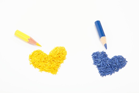 Color pencils and two hearts isolated on white background.の写真素材
