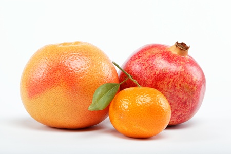 pomegranates and citrus fruits isolated on a white background.の写真素材