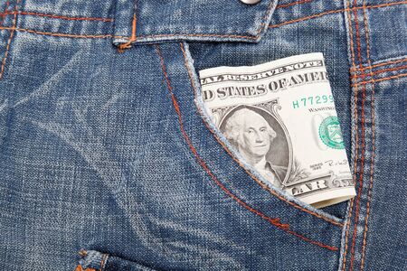 Dollar bill in his pocket jeans.