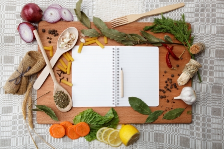 notebook for recipes and spices on wooden tableの写真素材