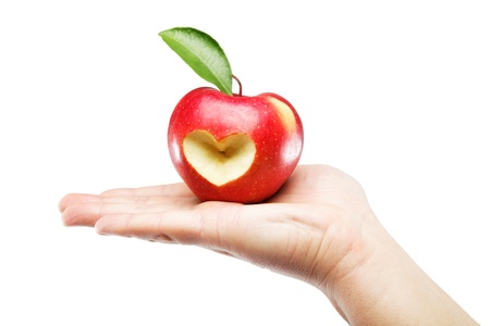 Woman's hand with an apple isolated on white background.の写真素材
