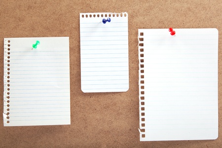 Blank notes with buttons on a wooden board の写真素材