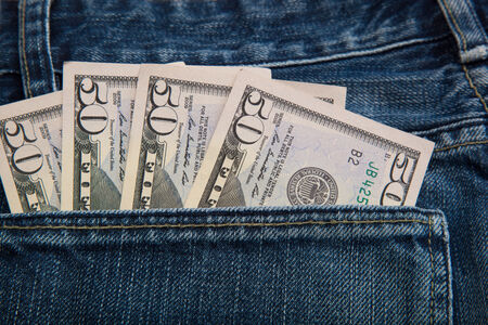 Banknotes in the back pocket of jeans.