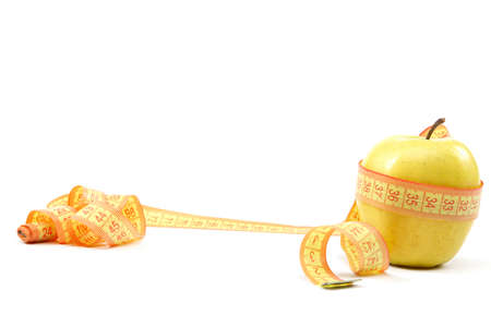 Fresh apple and measuring tape isolated on a white background.の写真素材