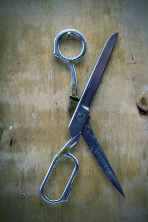 Old tailoring scissors on the wooden wall.の写真素材