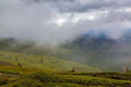 Rain clouds on the mountain top.の写真素材