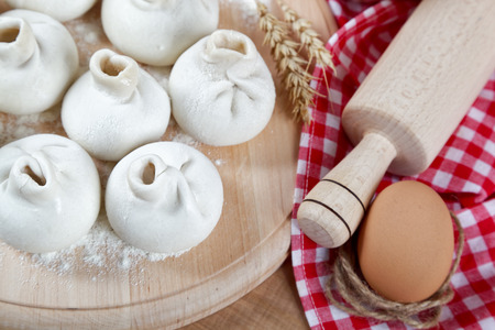 Baking ingredients for cooking manti dumplings on a wooden board.の写真素材