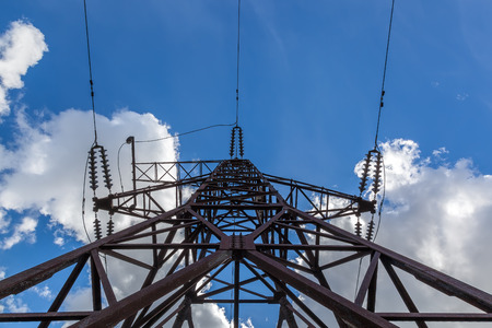 High-voltage line on a background of blue sky with clouds.