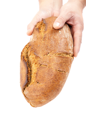 Fresh bread in the hands isolated on white background.の写真素材