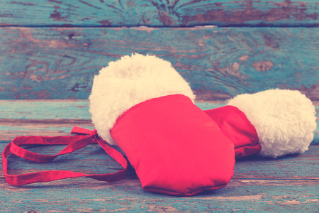 Red mittens with fur on painted blue wooden boards.の写真素材