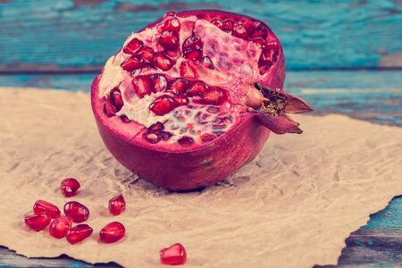 Fresh pomegranate on painted blue wooden boards.の写真素材