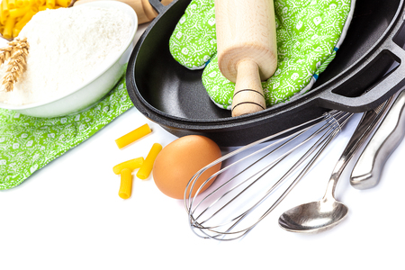 Kitchen utensils, eggs, flour for baking and frying pan isolated on white background.の写真素材