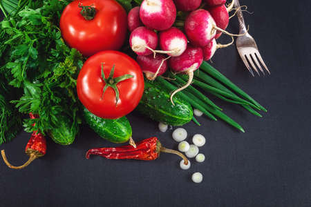 Fresh vegetables on a black background.