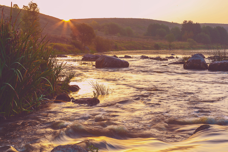 Mountain river with rapids in the morning mist.の写真素材
