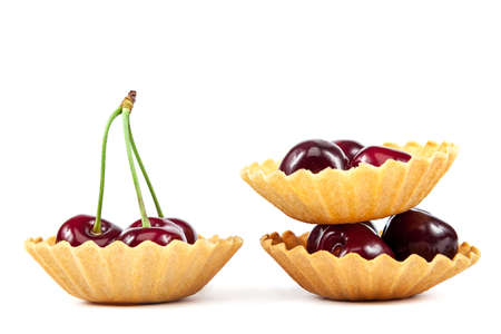 Fresh a sweet cherry fruits in baskets of sand isolated on a white background.の写真素材