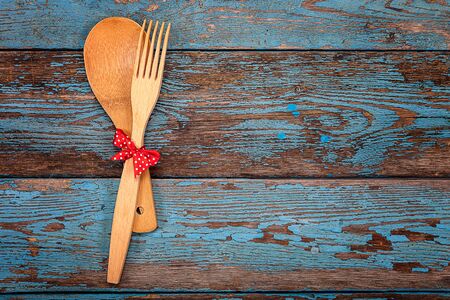 Spoon and fork. Set kitchen utensils on a wooden background. Accessories for cooking.の写真素材