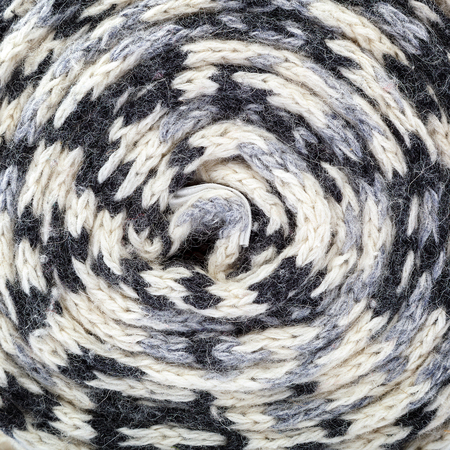 Scarf knitted colorful roll as a background.