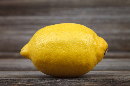 Fresh lemon on the a wooden background.の写真素材