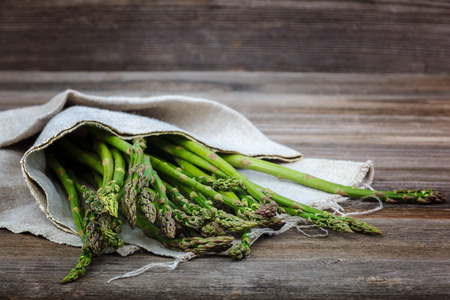 Asparagus green fresh on a wooden background.の写真素材