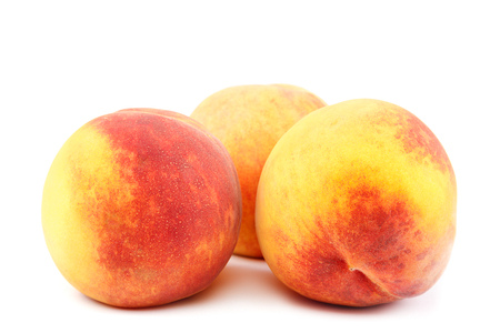 Fresh peach fruits isolated on white background.の写真素材
