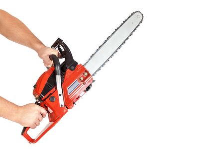 Chainsaw in a male hand isolated on a white background.の写真素材