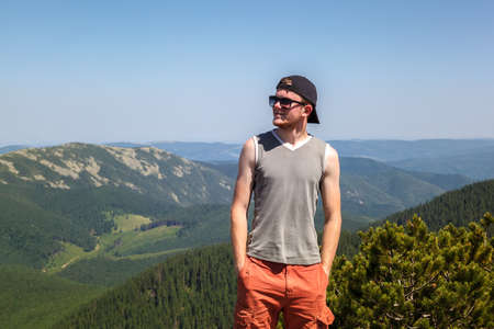 Young man traveling on a mountain top.の写真素材