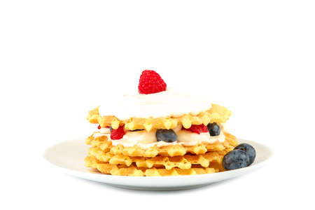 Fresh blueberries, raspberries and waffle cookies isolated on a white background.の写真素材