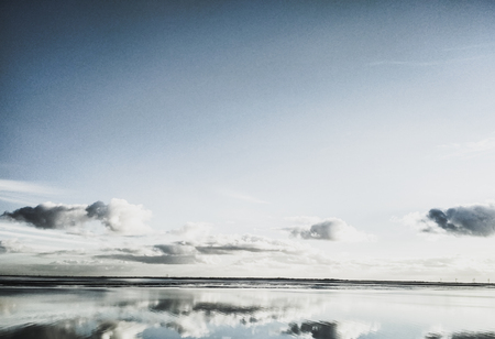 Reflections in the water on a sunny day at Wilhelmshaven Beach, Suedstrandの写真素材