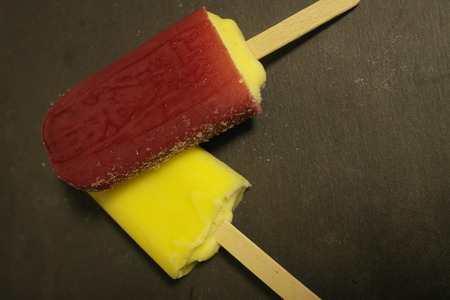 red strawberries and yellow lemon ice cream for dessertの写真素材