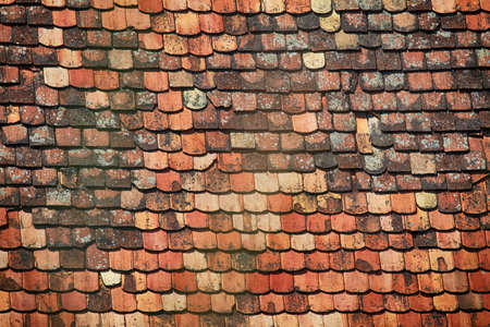 Old and ruined roofs. Texture of a roof with old roof tiles.の写真素材
