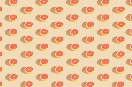 Creative pattern with organic grapefruit made and beige background.Minimal summer fruit layoutの写真素材