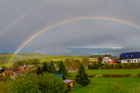 Beautiful rainbow over the roofs of the town of Schmalkalden - Thuringia - Germanyの写真素材