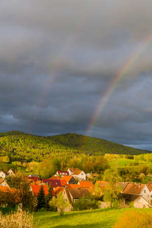 Beautiful rainbow over the roofs of the town of Schmalkalden - Thuringia - Germanyの写真素材